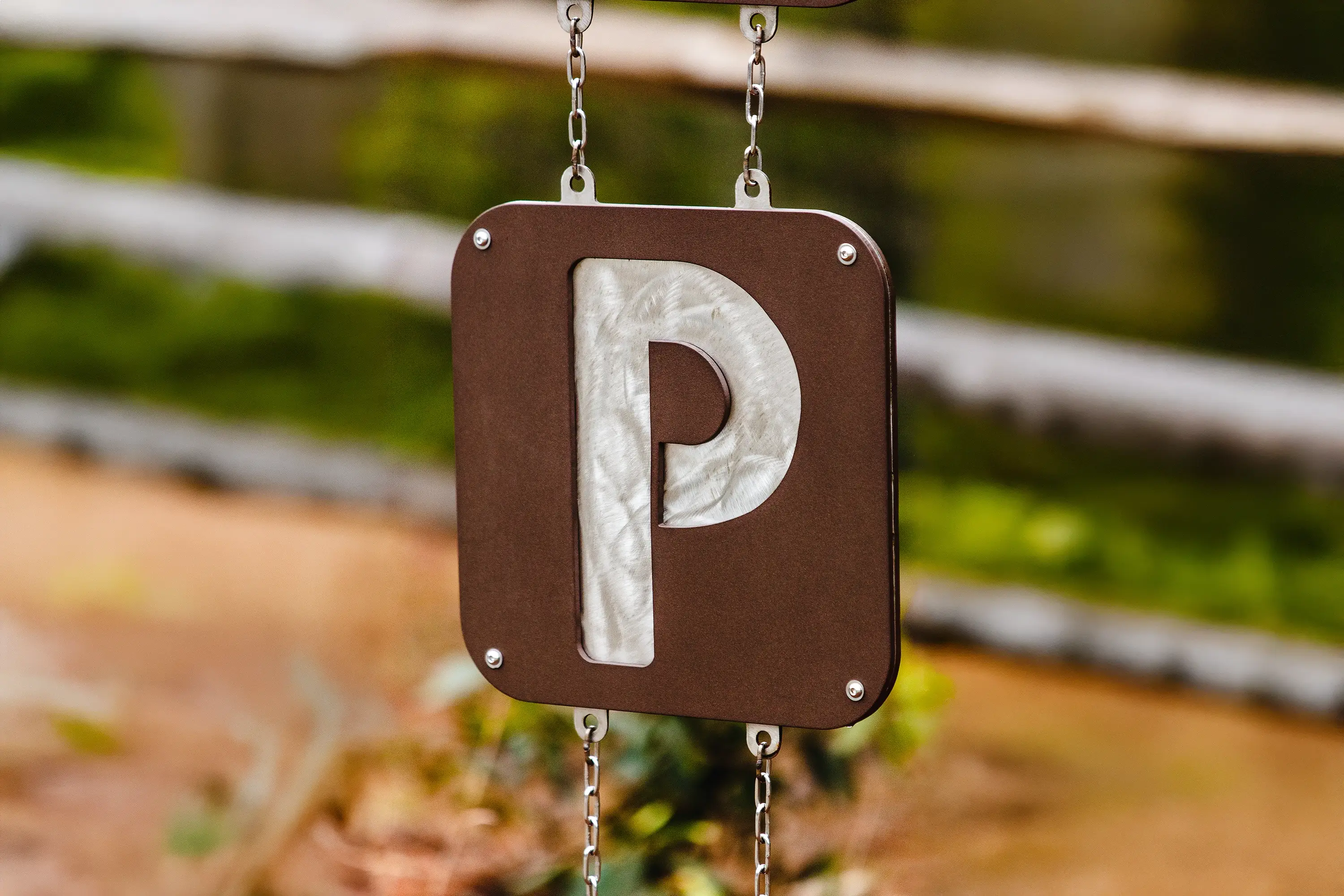 A close-up detail shot of the parking placard in the Middle Fork Greenway trailhead monument