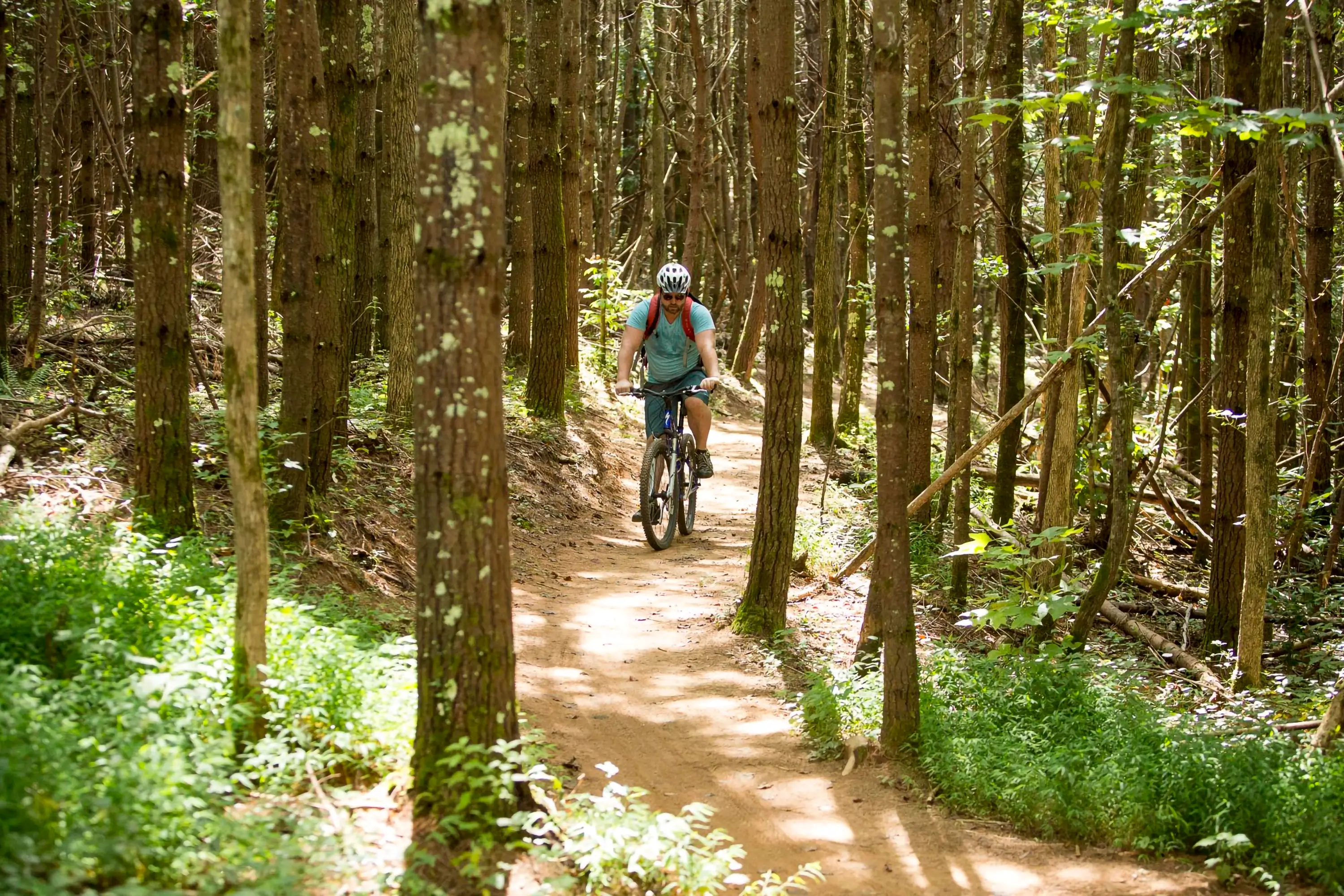 Alex riding a bike on the Fonta Flora trail