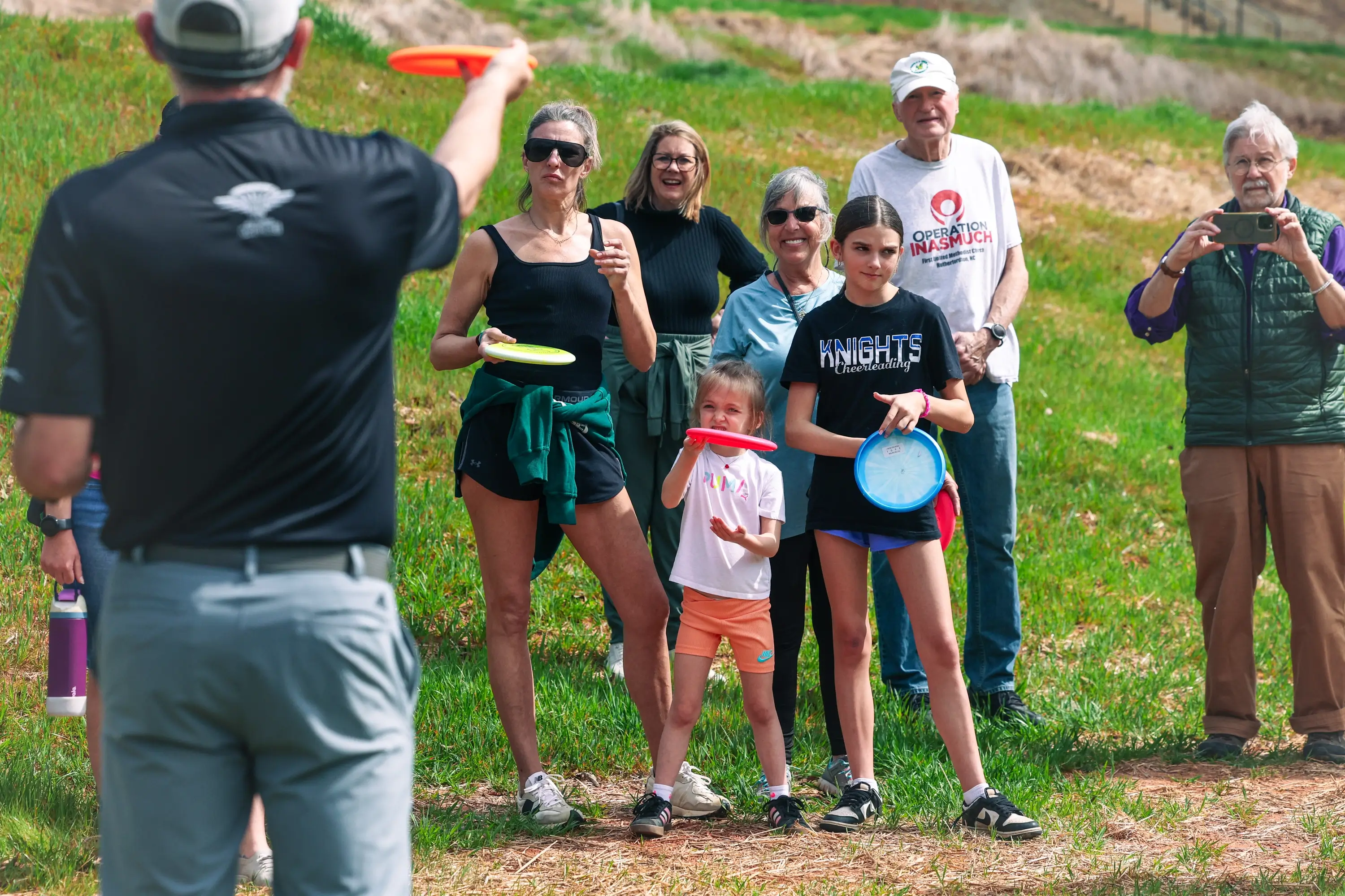A family tossing discs back and forth