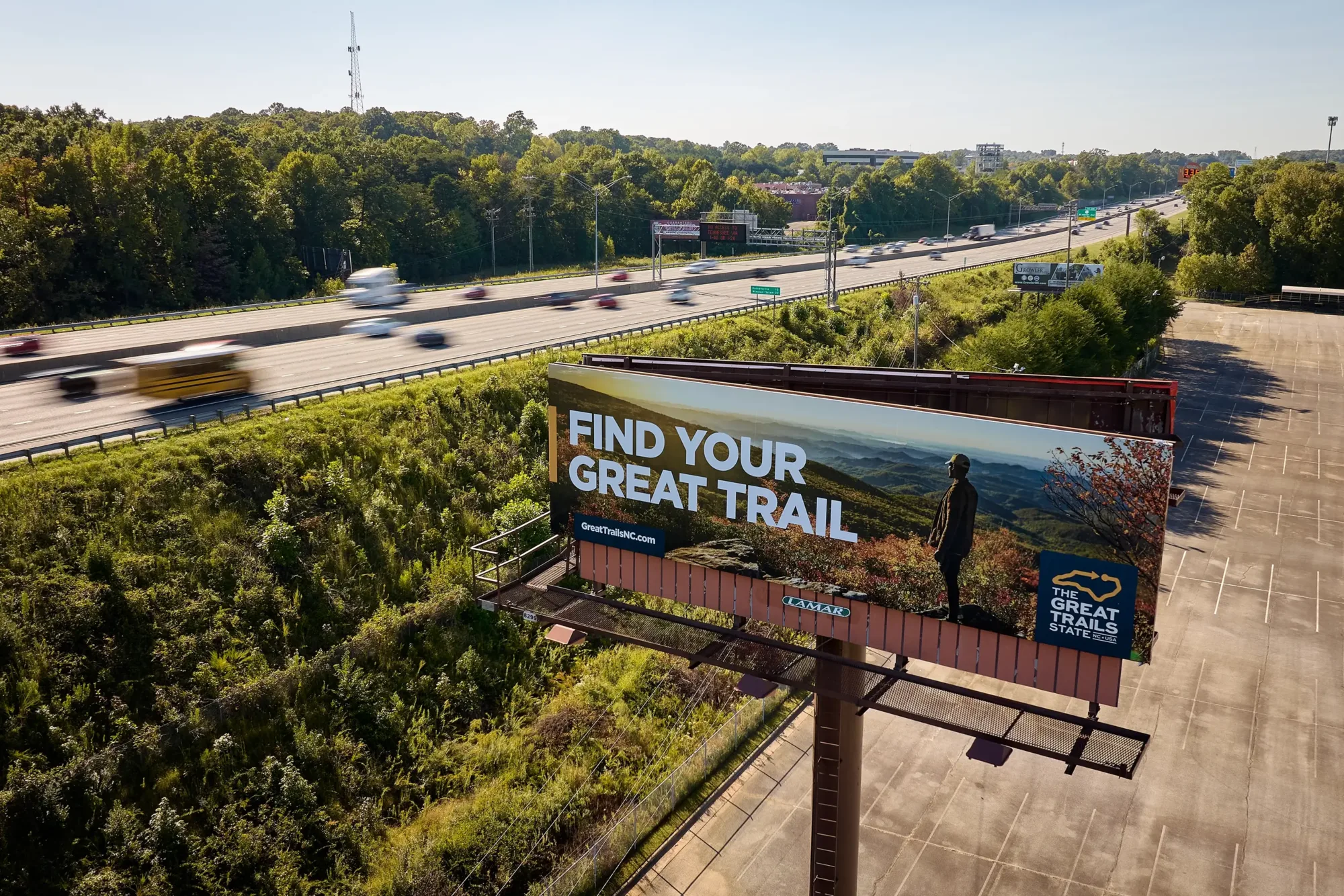 A Year of the Trail billboard by a highway