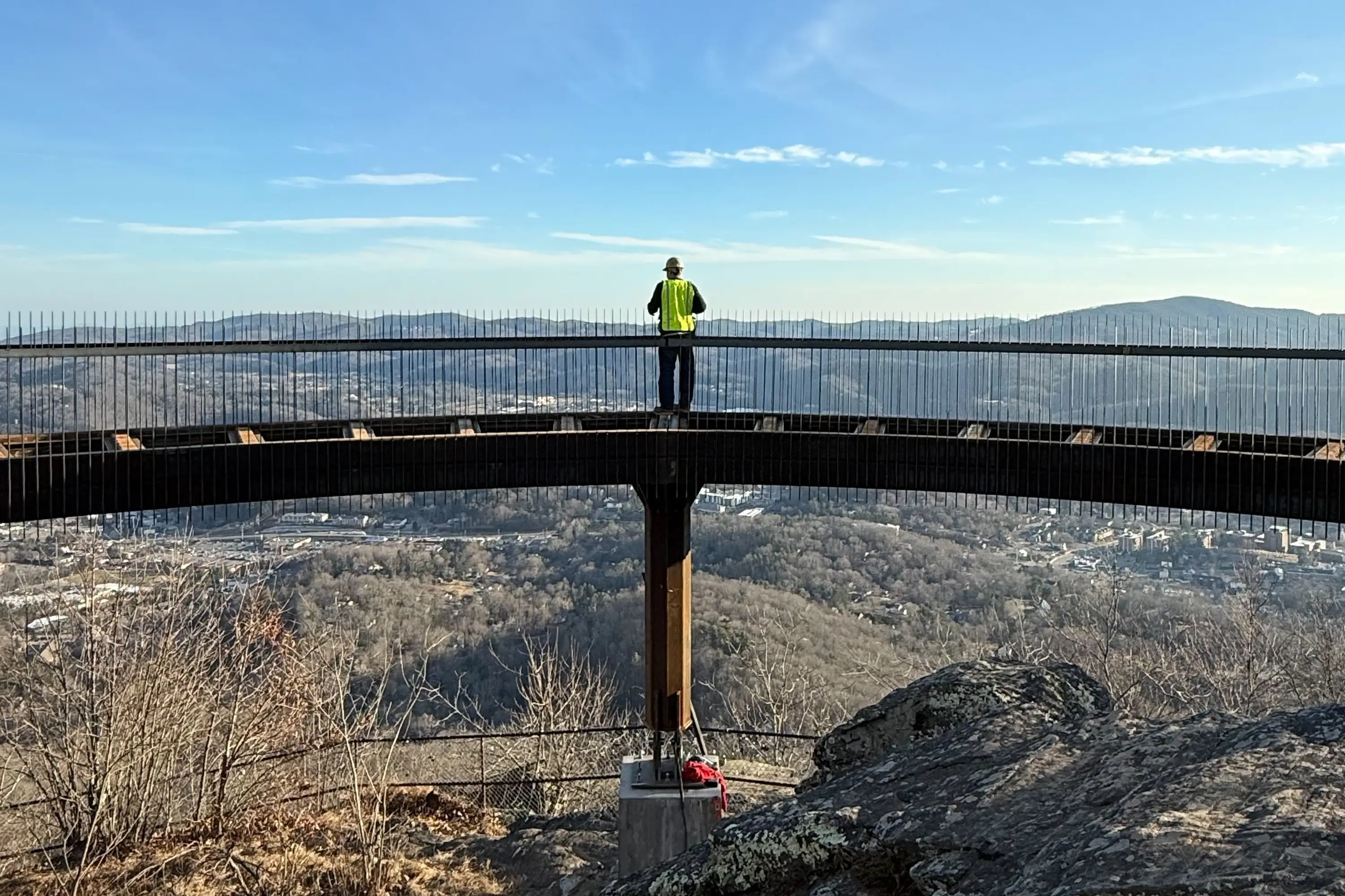 A construction worker standing at the center of the overview