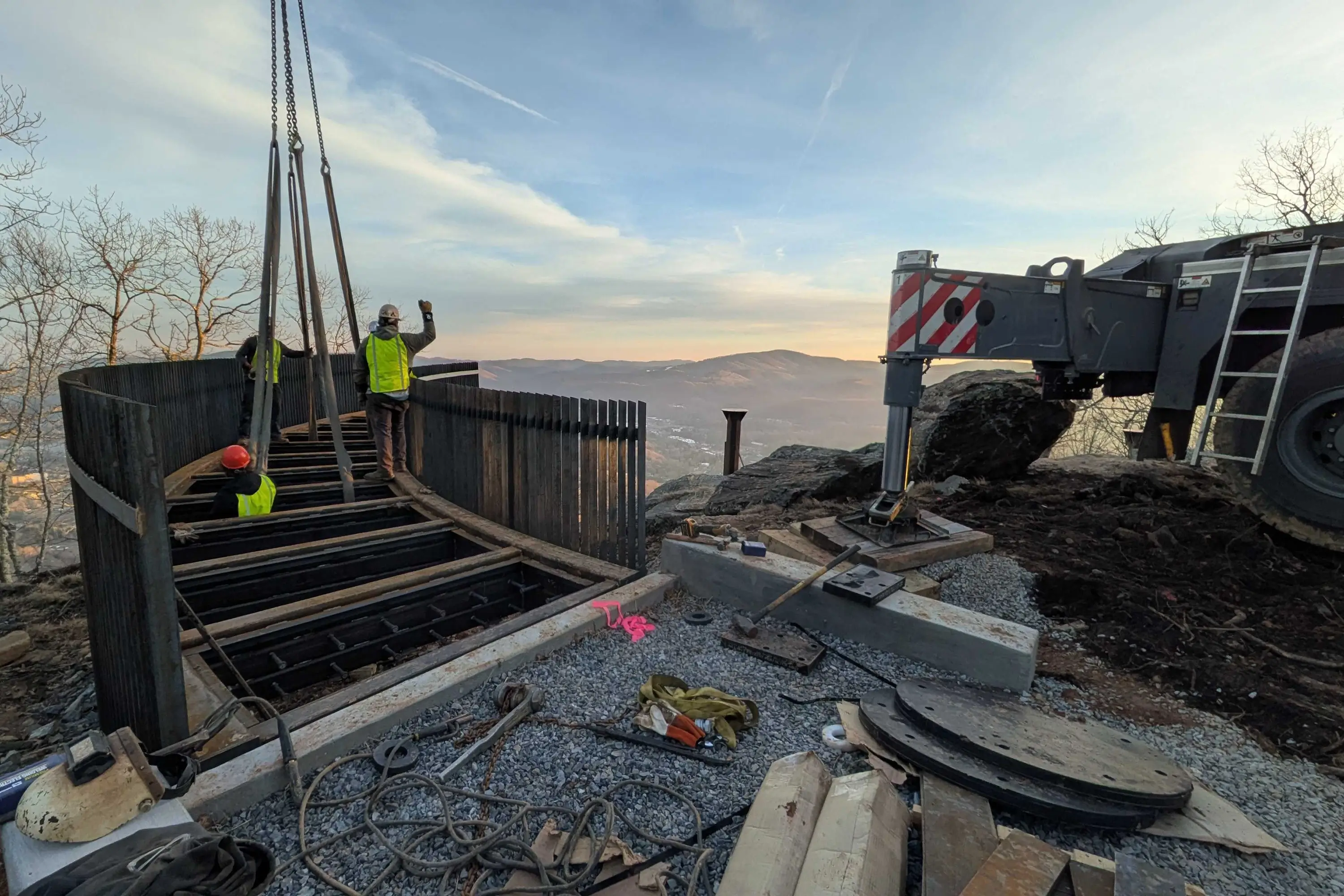 A construction group directing a crane setting the overview foundation