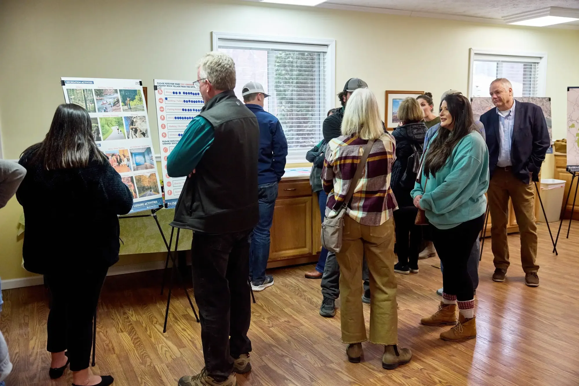 A group of people viewing boards displaying disaster recovery plans