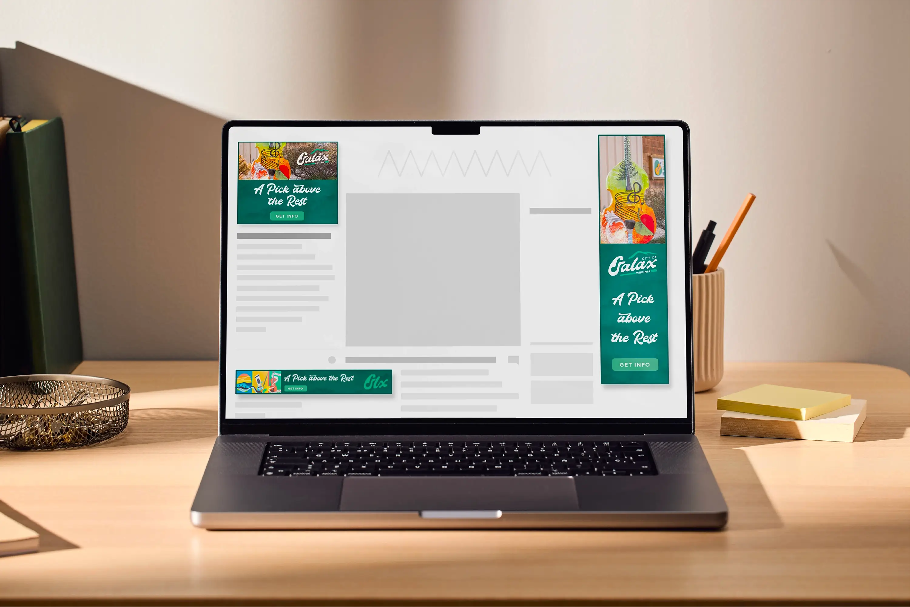 A mockup of ad designs on a laptop screen