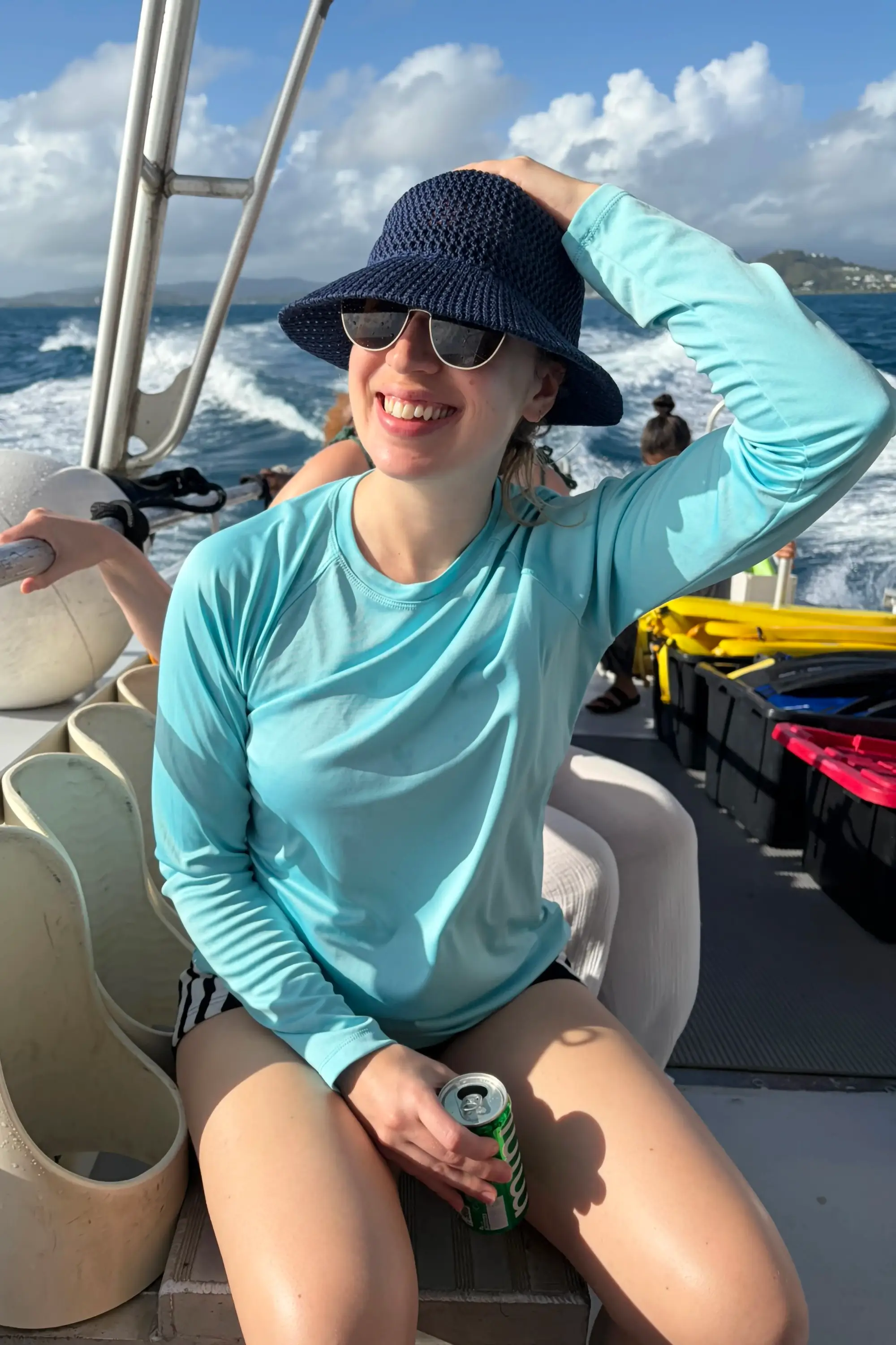 Holly Waterman sitting on a boat in the sea