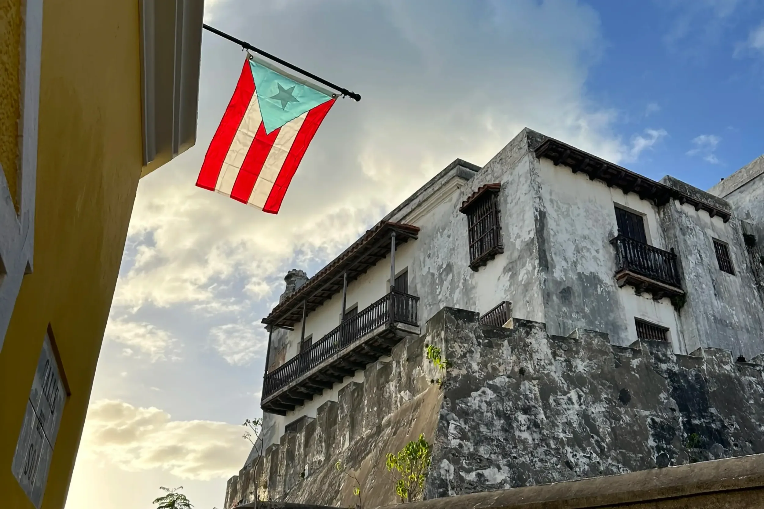 A Puerto Rican flag flying in front of a building