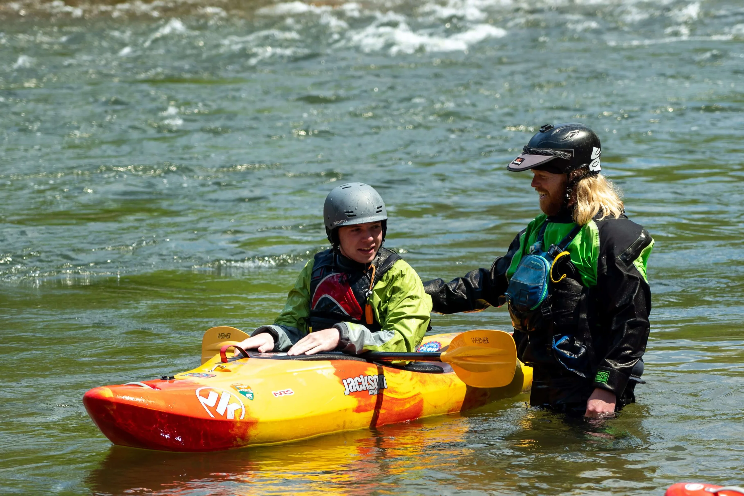 A paddle guide by a man in the river