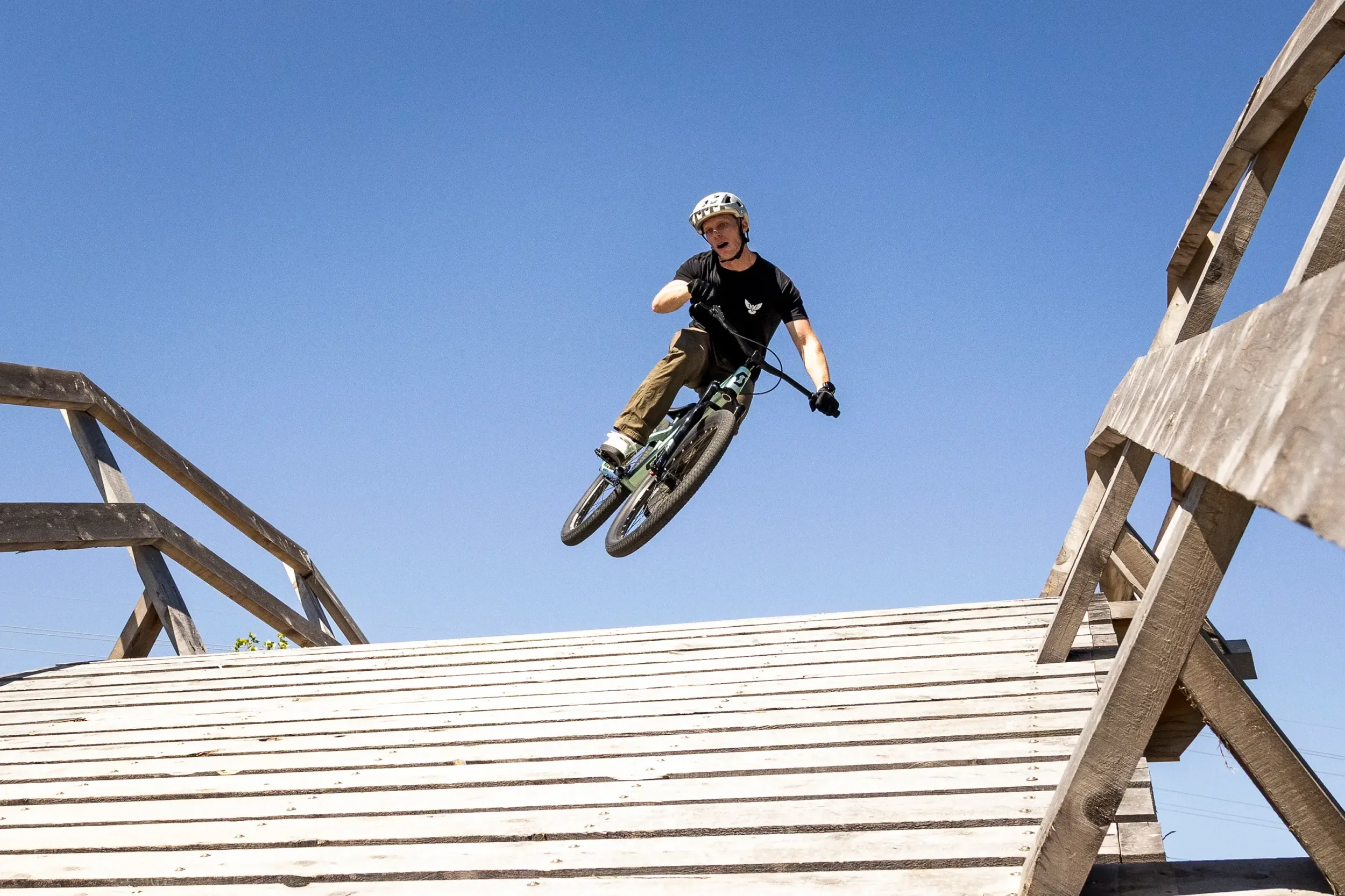 A close-up of a man jumping a ramp