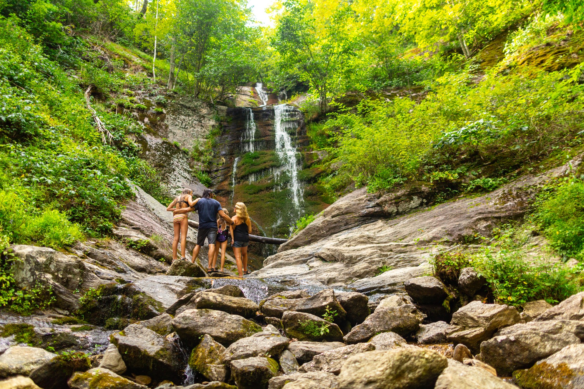 Family hiking on rocks.