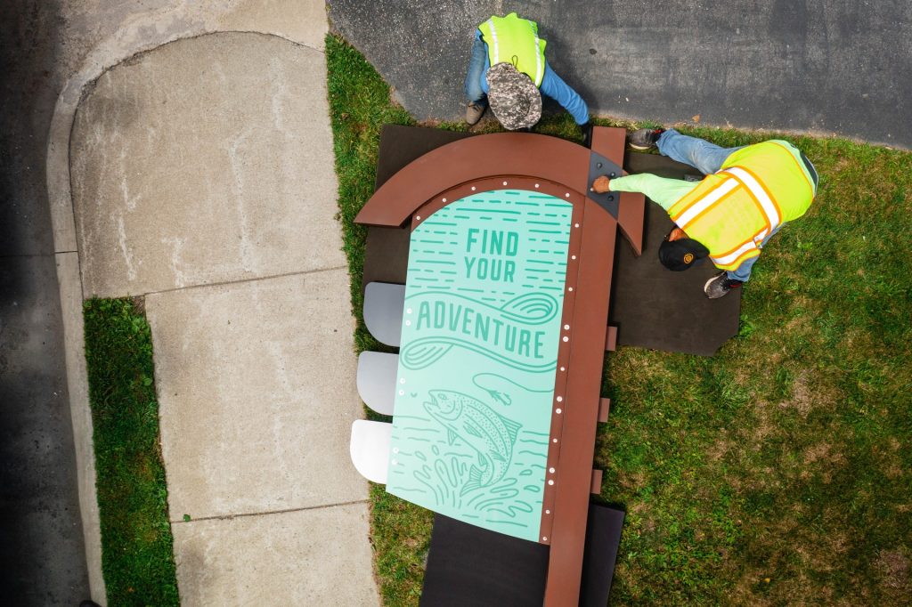 Construction workers assembling the Watauga Wayfinding signage