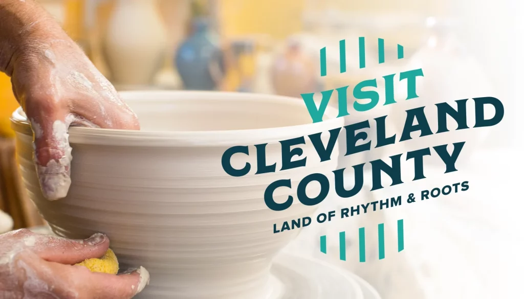 A potter's hands around a bowl with the Visit Cleveland County logo overlaid