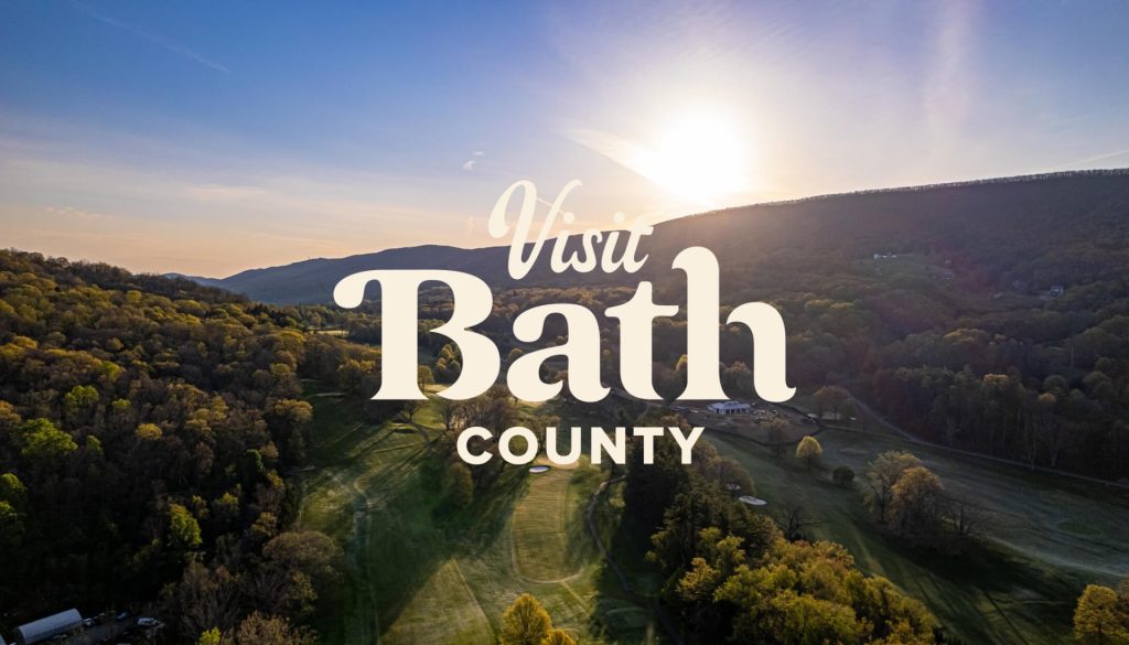 An aerial landscape shot of moutains with the overlaid Visit Bath County logo